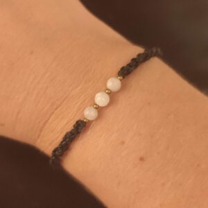 Cette photo représente un bracelet avec des perles de pierre de lune.